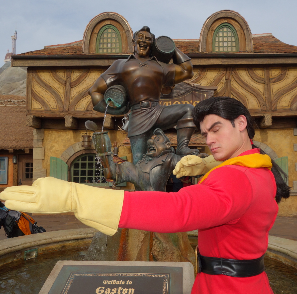 Gaston demonstrates the proper technique for shooting an arrow of love into a young lady's heart.  He said he has 323 offers for marriage in the village but is just waiting on Belle to "come to her senses."