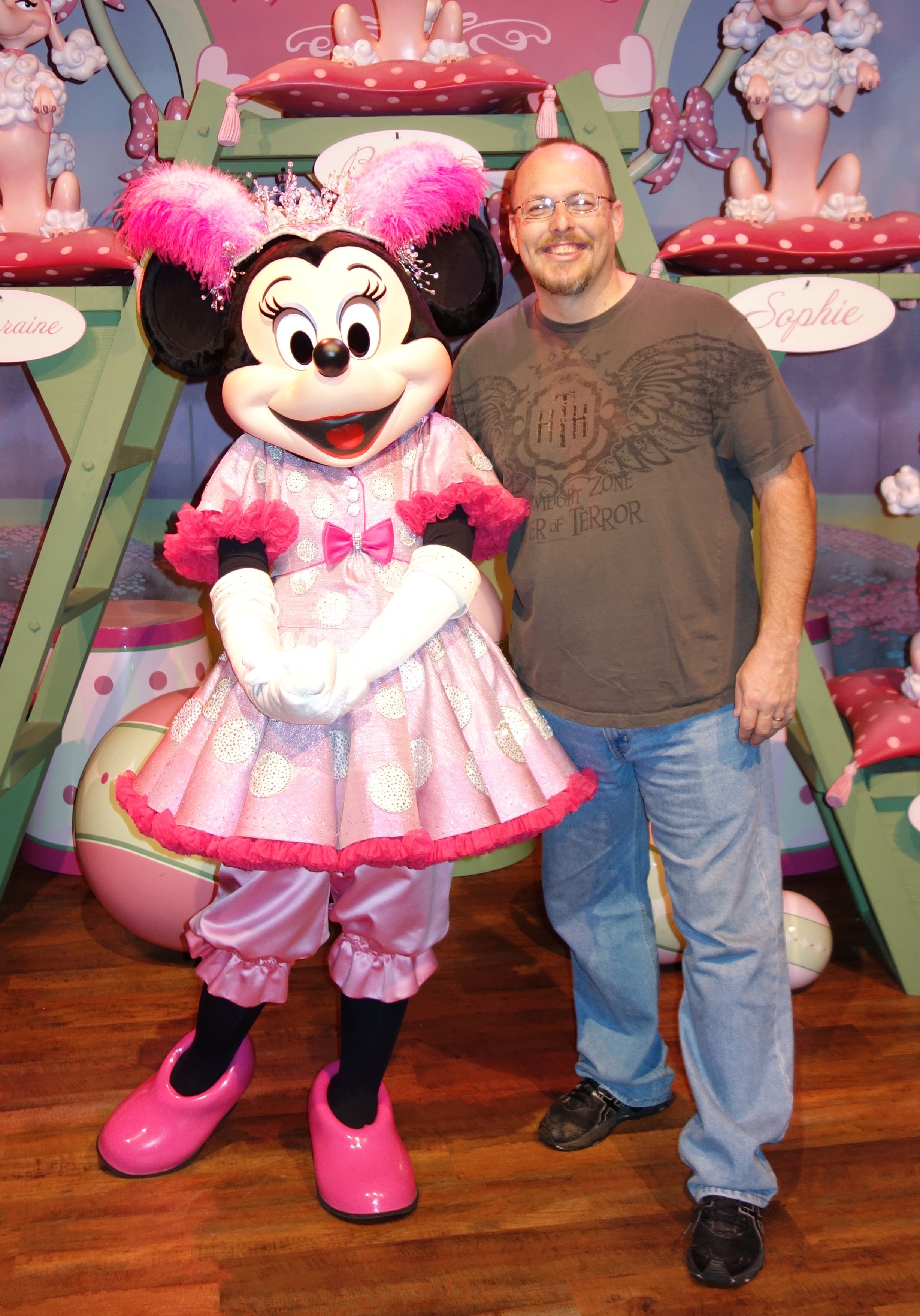 I need a fun idea for a mid-forties married man with children to pose with Minnie Mouse in this location.  I can't do the dancer pose!
